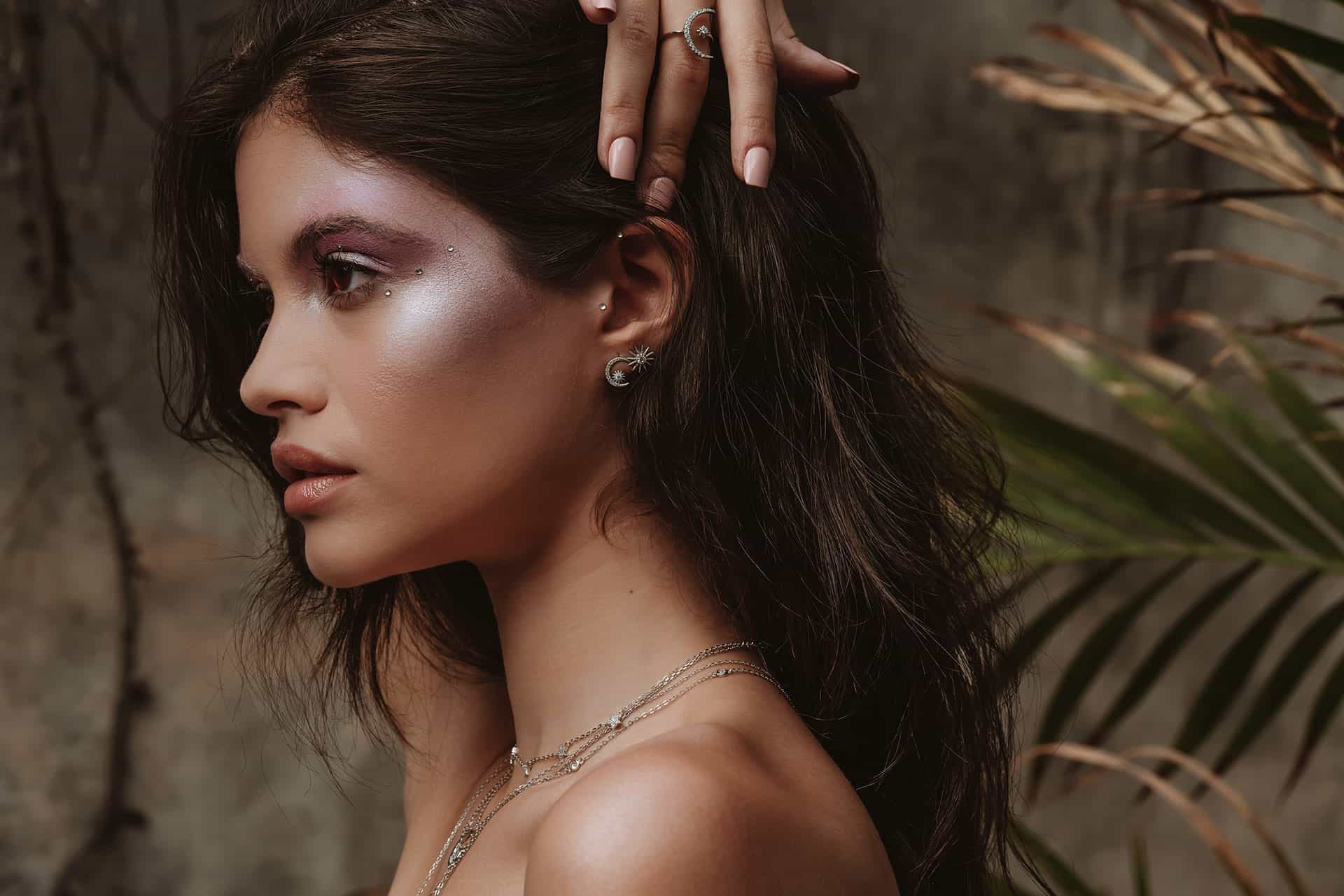 Close-up of gold-plated hoop earrings with soft background lighting