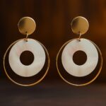 “GlowingFusions round hoop drop earrings with white circular center and golden metal outline – stylish artificial jewelry for women.”