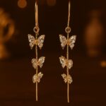 Artificial gold-tone butterfly drop earrings with crystal accents
